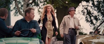 Movie still from “R.I.P.D.” (2013), directed by Robert Schwentke – A woman walking down a street with two men; Medium shot, Over the shoulder angle