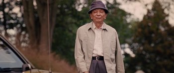 Movie still from “R.I.P.D.” (2013), directed by Robert Schwentke – An older man wearing a hat and a jacket; Medium shot, Low angle