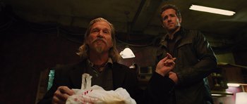 Movie still from “R.I.P.D.” (2013), directed by Robert Schwentke – Two men standing next to each other in a dark room; Medium shot, Low angle