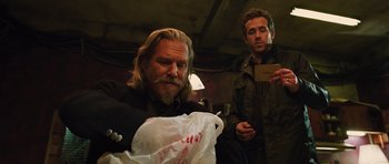 Movie still from “R.I.P.D.” (2013), directed by Robert Schwentke – A man sitting next to another man holding a bag of food; Medium shot, Over the shoulder angle