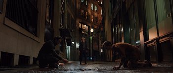 Movie still from “R.I.P.D.” (2013), directed by Robert Schwentke – A group of people standing on a street at night; Wide shot, High angle