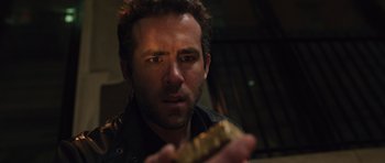 Movie still from “R.I.P.D.” (2013), directed by Robert Schwentke – A person holding a piece of food; Close Up shot, High angle