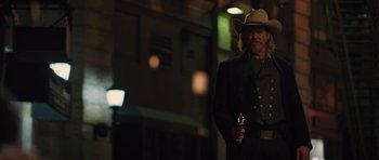 Movie still from “R.I.P.D.” (2013), directed by Robert Schwentke – A man wearing a cowboy hat and holding a gun; Medium shot, Low angle