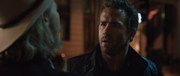 Movie still from “R.I.P.D.” (2013), directed by Robert Schwentke – A person talking to another person; Close Up shot, Over the shoulder angle