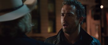 Movie still from “R.I.P.D.” (2013), directed by Robert Schwentke – A person wearing a black jacket; Close Up shot, Over the shoulder angle