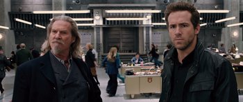 Movie still from “R.I.P.D.” (2013), directed by Robert Schwentke – A group of people standing in a room with tables; Close Up shot, Over the shoulder angle