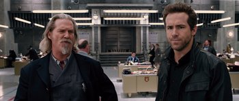 Movie still from “R.I.P.D.” (2013), directed by Robert Schwentke – Two men standing next to each other in front of a building; Medium shot, Over the shoulder angle
