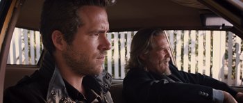 Movie still from “R.I.P.D.” (2013), directed by Robert Schwentke – Two men sitting in the back seat of a car; Close Up shot, Over the shoulder angle