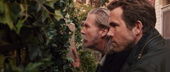 Movie still from “R.I.P.D.” (2013), directed by Robert Schwentke – Two men with long grey hair and beards looking at a bush; Close Up shot, Over the shoulder angle