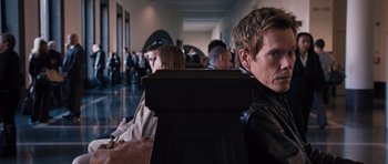 Movie still from “R.I.P.D.” (2013), directed by Robert Schwentke – A group of people sitting in a room; Close Up shot, Over the shoulder angle