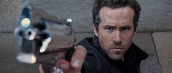 Movie still from “R.I.P.D.” (2013), directed by Robert Schwentke – A person holding a gun; Close Up shot, Low angle