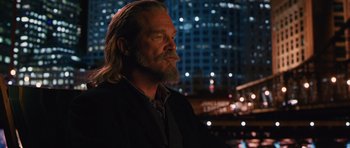 Movie still from “R.I.P.D.” (2013), directed by Robert Schwentke – A man with long hair and a long beard is standing in front of a city skyline at night; Close Up shot, Over the shoulder angle
