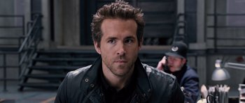 Movie still from “R.I.P.D.” (2013), directed by Robert Schwentke – A person wearing a leather jacket; Close Up shot, Over the shoulder angle