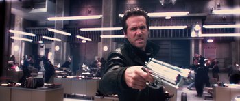 Movie still from “R.I.P.D.” (2013), directed by Robert Schwentke – A man in a black jacket holding a gun in his hand; Close Up shot, Low angle