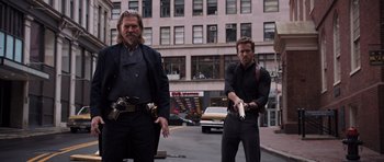 Movie still from “R.I.P.D.” (2013), directed by Robert Schwentke – A couple of men standing next to each other on a street; Medium shot, Low angle