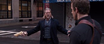 Movie still from “R.I.P.D.” (2013), directed by Robert Schwentke – A man with long hair and a goatee standing on the street; Medium shot, Over the shoulder angle