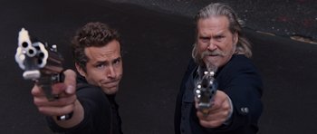 Movie still from “R.I.P.D.” (2013), directed by Robert Schwentke – A man holding a gun next to another man with a gun; Close Up shot, Low angle