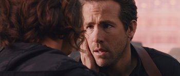 Movie still from “R.I.P.D.” (2013), directed by Robert Schwentke – A person with his hand on his ear; Close Up shot, Over the shoulder angle