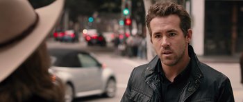 Movie still from “R.I.P.D.” (2013), directed by Robert Schwentke – A person on a city street; Close Up shot, Over the shoulder angle