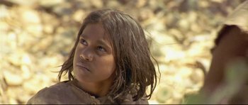 Movie still from “Rabbit-Proof Fence” (2002), directed by Phillip Noyce – A young girl with long brown hair looking to her left; Close Up shot, High angle