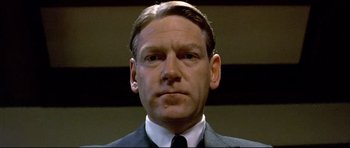 Movie still from “Rabbit-Proof Fence” (2002), directed by Phillip Noyce – A person wearing a suit and tie; Close Up shot, Low angle