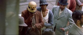 Movie still from “Rabbit-Proof Fence” (2002), directed by Phillip Noyce – A man and a woman sitting next to each other on a bench; Medium shot, High angle