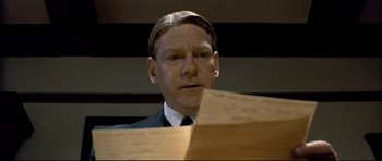 Movie still from “Rabbit-Proof Fence” (2002), directed by Phillip Noyce – A person wearing a suit and tie; Close Up shot, Low angle