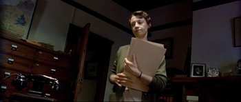 Movie still from “Rabbit-Proof Fence” (2002), directed by Phillip Noyce – A woman holding a stack of papers in her hands; Medium shot, Low angle