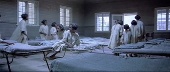 Movie still from “Rabbit-Proof Fence” (2002), directed by Phillip Noyce – A group of women sitting on top of mattresses; Wide shot, High angle