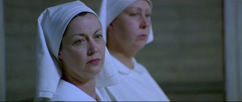 Movie still from “Rabbit-Proof Fence” (2002), directed by Phillip Noyce – Two women dressed in white are standing next to each other; Close Up shot, Low angle