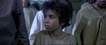 Movie still from “Rabbit-Proof Fence” (2002), directed by Phillip Noyce – A young boy is looking into the distance; Close Up shot, Over the shoulder angle