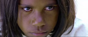Movie still from “Rabbit-Proof Fence” (2002), directed by Phillip Noyce – A young girl's face with blue eyes; Extreme Close Up shot, High angle