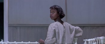 Movie still from “Rabbit-Proof Fence” (2002), directed by Phillip Noyce – A young girl in a white shirt is looking up; Close Up shot, Low angle