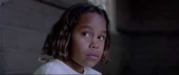 Movie still from “Rabbit-Proof Fence” (2002), directed by Phillip Noyce – A young person with long black hair; Close Up shot, High angle