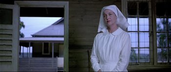 Movie still from “Rabbit-Proof Fence” (2002), directed by Phillip Noyce – A woman wearing a white dress and a white hat; Medium shot, Low angle
