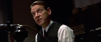 Movie still from “Rabbit-Proof Fence” (2002), directed by Phillip Noyce – A man wearing a black vest and a white shirt; Close Up shot, Low angle