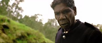 Movie still from “Rabbit-Proof Fence” (2002), directed by Phillip Noyce – An old man with a black shirt and a black jacket; Close Up shot, Over the shoulder angle