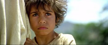 Movie still from “Rabbit-Proof Fence” (2002), directed by Phillip Noyce – A young person with short brown hair; Close Up shot, High angle