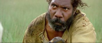 Movie still from “Rabbit-Proof Fence” (2002), directed by Phillip Noyce – A man with a beard is looking at the camera; Close Up shot, High angle