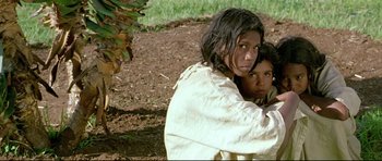Movie still from “Rabbit-Proof Fence” (2002), directed by Phillip Noyce – A woman and a child are standing in the dirt; Medium shot, Low angle