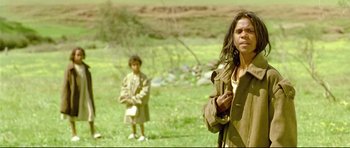 Movie still from “Rabbit-Proof Fence” (2002), directed by Phillip Noyce – A woman and a child in a field; Medium shot, High angle