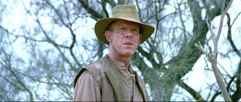 Movie still from “Rabbit-Proof Fence” (2002), directed by Phillip Noyce – A person wearing a hat near a tree; Close Up shot, Low angle