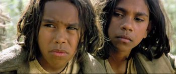 Movie still from “Rabbit-Proof Fence” (2002), directed by Phillip Noyce – Two young people standing next to each other; Close Up shot, High angle