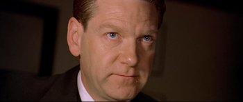 Movie still from “Rabbit-Proof Fence” (2002), directed by Phillip Noyce – A person wearing a suit and tie; Close Up shot, High angle
