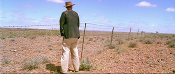 Movie still from “Rabbit-Proof Fence” (2002), directed by Phillip Noyce – A man standing in the middle of an open field; Wide shot, Low angle