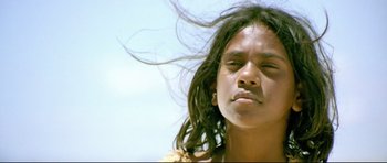 Movie still from “Rabbit-Proof Fence” (2002), directed by Phillip Noyce – A young girl with long hair blowing in the wind; Close Up shot, High angle