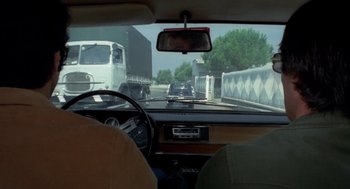 Movie still from “Rabid Dogs” (1974), directed by Mario Bava – A view from inside a car looking out the windshield; Medium shot, Over the shoulder angle