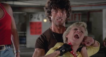 Movie still from “Rabid Dogs” (1974), directed by Mario Bava – A man and a woman in a parking garage; Close Up shot, Low angle