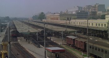 Movie still from “Rabid Dogs” (1974), directed by Mario Bava – A train station with many trains on the tracks; Extreme Wide shot, High angle