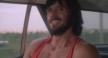 Movie still from “Rabid Dogs” (1974), directed by Mario Bava – A person with a beard in a car; Close Up shot, Low angle